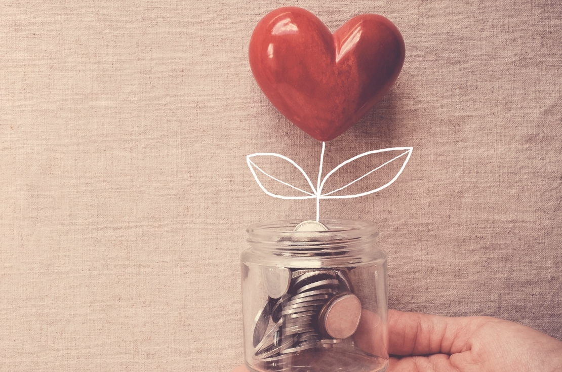 Hand holding jar with heart